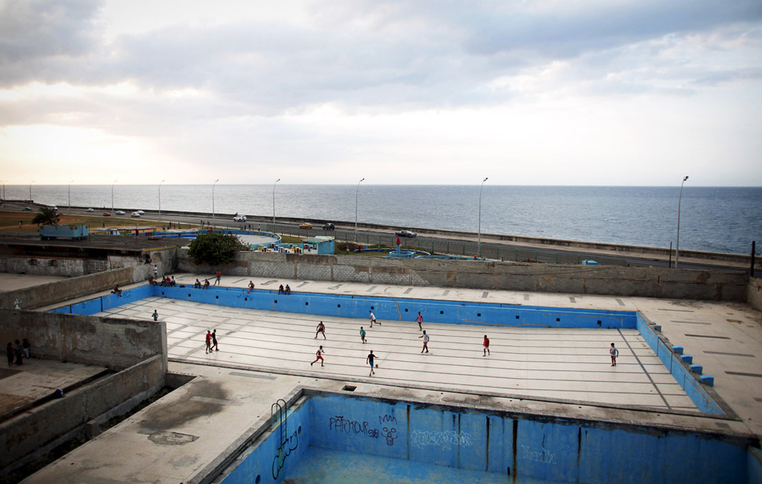 Молодежь играет в футбол в пустом бассейне в парке Гаваны, Куба