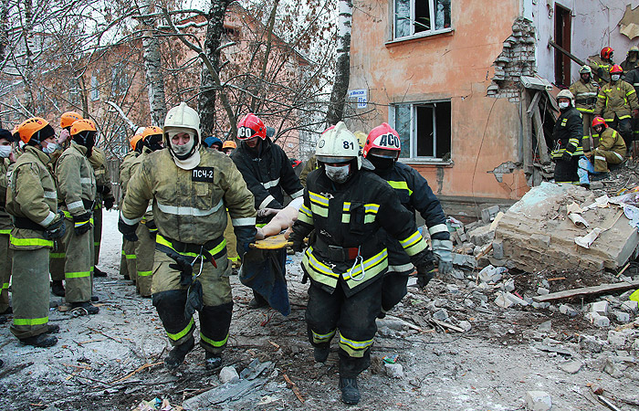 Пострадавшего человека выносят из дома после взрыва